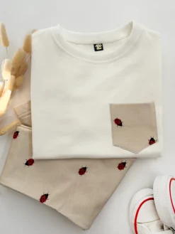 Komplet dla dziecka koszulka z kieszonką + legginsy biedronki na beżu